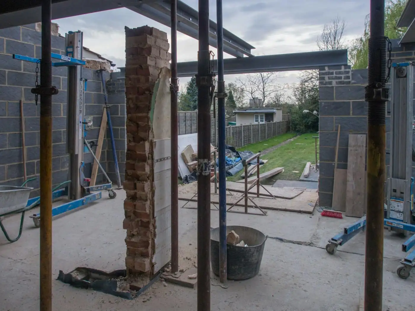 New reinforced concrete columns and beams of a rear extension beside an existing house